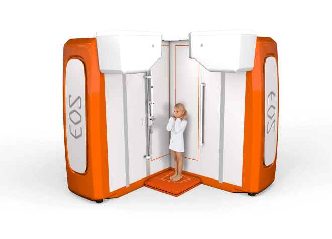 A pediatric patient stands on a specialized EOS imaging platform as a medical professional conducts a diagnostic procedure. The EOSedge system captures detailed diagnostic images of the patient's body.